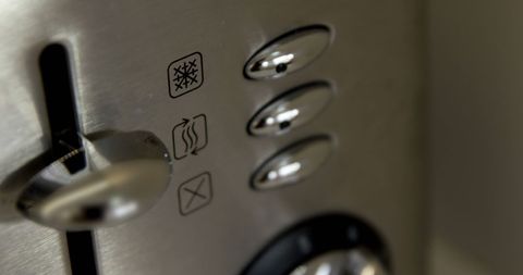 Close-up of toaster with control buttons in modern kitchen