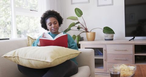 Woman Relaxing at Home Enjoying Book