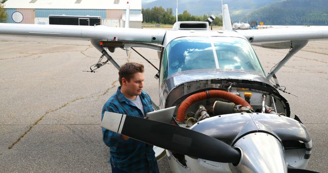 Mechanic Inspecting Hangar-Centered Small Aircraft - Download Free Stock Images Pikwizard.com