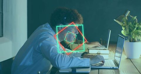 Night coworking worker typing on laptop wearing headphones neon geometric overlays
