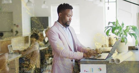 Professional Man in Modern Office Using Laptop for Business