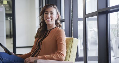 Confident Businesswoman in Modern Office Using Tablet