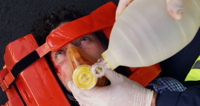 Emergency medical technician placing an oxygen mask on his wounded person