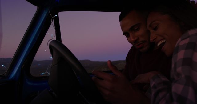 Couple enjoying digital map on road trip at sunset - Download Free Stock Images Pikwizard.com