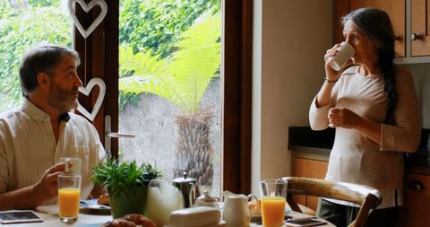 Couple Enjoying Breakfast and Conversation in Cozy Kitchen