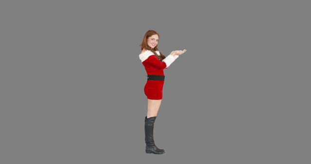 Smiling Woman in Santa Costume Presenting Something - Download Free Stock Images Pikwizard.com