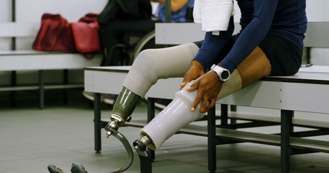 Determined Athlete with Prosthetic Leg Preparing for Training