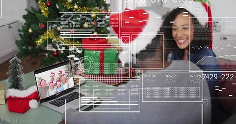 Family video call during holiday celebration showing festive living room, laptop and hud