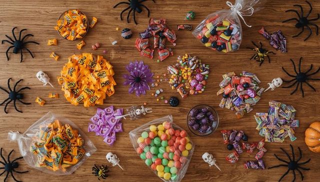 Vibrant halloween candy flat lay with spooky decorations