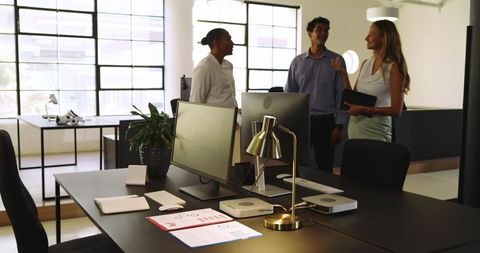 Colleagues Engaging in Collaborative Meeting in Bright Office