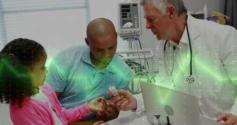 Pediatric clinic consultation demonstrating handheld medical monitor with family engagement