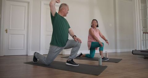 Senior Couple Enjoying Home Workout with Yoga and Stretching