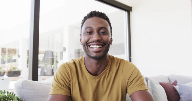 Confident African American Man Smiling Indoors in Yellow Shirt - Download Free Stock Images Pikwizard.com