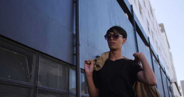 Stylish Young Man Wearing Sunglasses Walking in Urban Environment - Download Free Stock Images Pikwizard.com