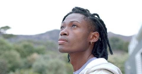 African american man gazing upward on hillside, contemplative casual portrait outdoors