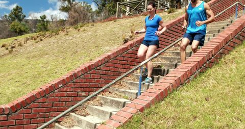 Fitness enthusiasts strengthening with outdoor stair workout
