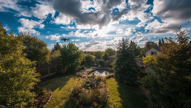 Serene suburban garden with central pond and ornamental stone fountain