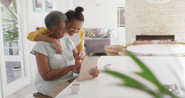 Happy African American Grandmother and Granddaughter Using Tablet in Bright Living Room - Download Free Stock Images Pikwizard.com