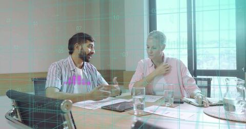 Colleagues Collaborating Over Data Analytics in Modern Office