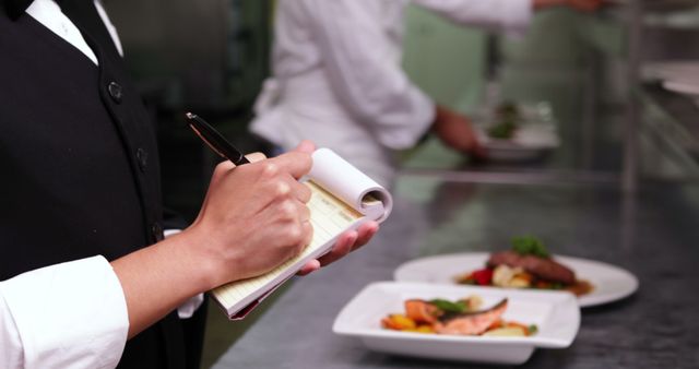 Waiter Taking Order in Restaurant Kitchen with Plated Meals - Download Free Stock Images Pikwizard.com