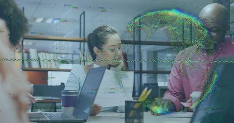 Woman leading team meeting in modern office with laptops, papers and digital glitch