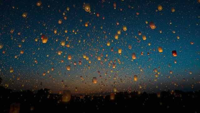 Illuminated Skylight Lanterns Floating During Night Festival