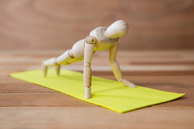 Conceptual image of figurine performing pushups exercise