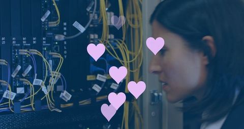 businesswoman in server room with digital hearts overlay - Download Free Stock Images Pikwizard.com
