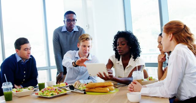 Diverse Team Collaborating During Business Lunch in Modern Office - Download Free Stock Images Pikwizard.com