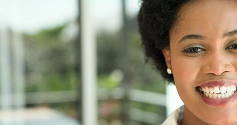 Joyful Woman Smiling on Modern Balcony with Natural Serenity