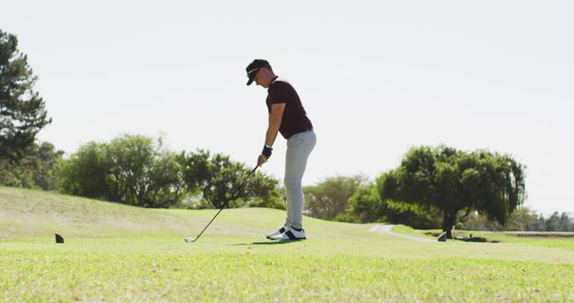 Image of caucasian man playing golf on golf filed. sporty, active lifestyle and playing golf concept.