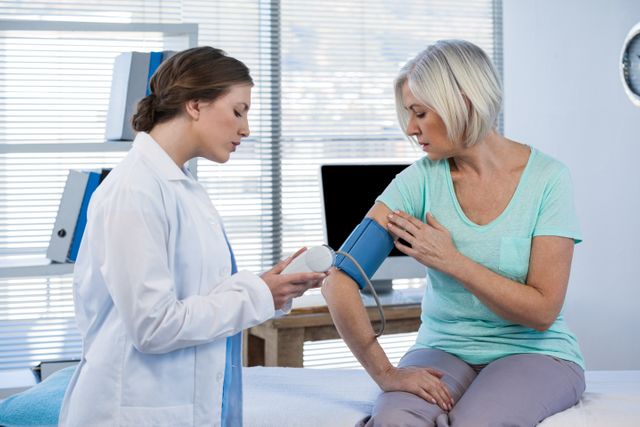 Female doctor checking blood pressure of a patient in the hospital