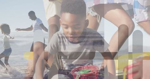 Boy Building Sandcastle with Family at Sunny Beach