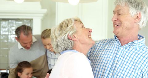 Senior Couple Enjoying Family Time with Multi-Generational Warmth - Download Free Stock Images Pikwizard.com