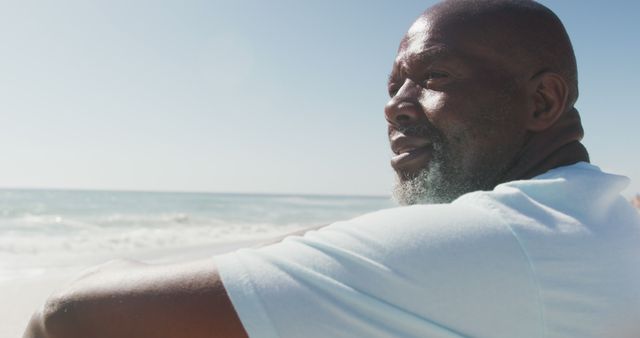 Thoughtful African American Man Reflecting at the Beach on a Sunny Day - Download Free Stock Images Pikwizard.com