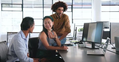 Diverse Team Collaborates on Project in Modern Office