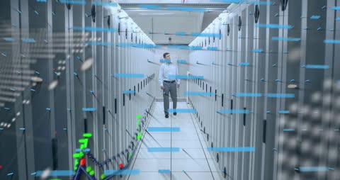Engineer Walking in Futuristic Data Center with Digital Overlays