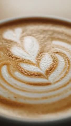 Focusing camera capturing latte art rosetta heart creamy espresso crema closeup video