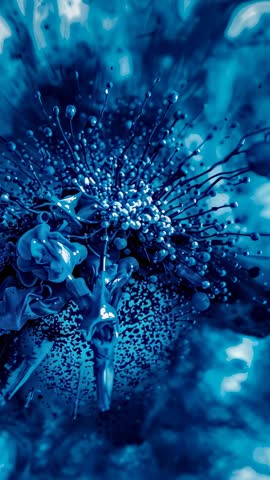 Zooming into blue macro core revealing bead tendrils, droplets and curling petals — vertical video