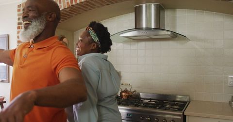 Joyful Senior African American Couple Dancing in Kitchen