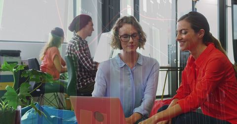 Collaborative Team Analyzing Financial Data on Laptop