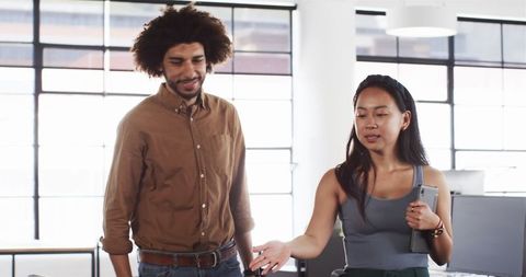 Diverse colleagues engaging warmly in office discussion