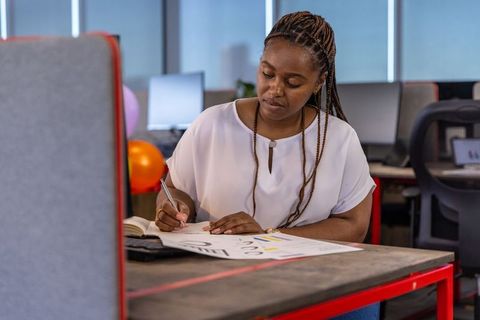 Focused african american professional analyzing data at modern office