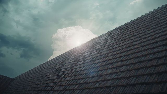 Sunny Cumulus Clouds Over Tiled Roof in Natural Light