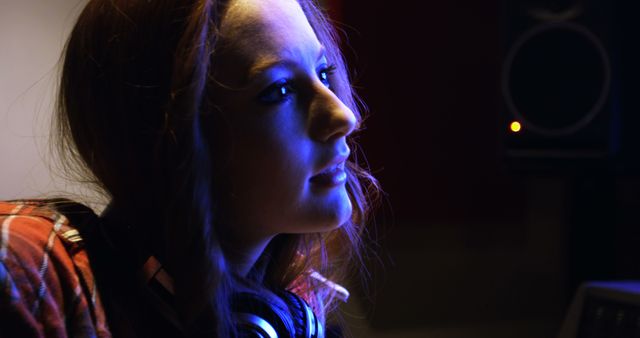 Young Woman Deep in Thought with Headphones in Recording Studio - Download Free Stock Images Pikwizard.com