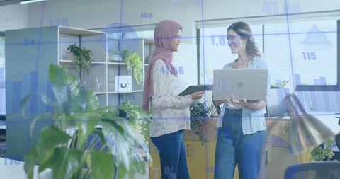 Diverse Professionals Analyzing Data in Modern Office