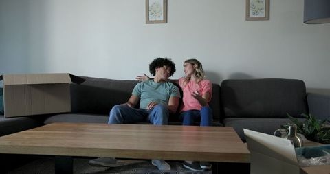 Couple Moving In and Arranging Living Room Space