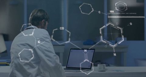 Scientist analyzing chemical structures on laptop in lab