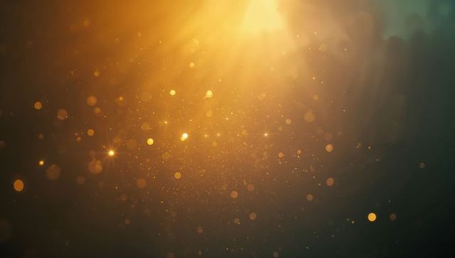 Glowing particles with golden bokeh under warm light