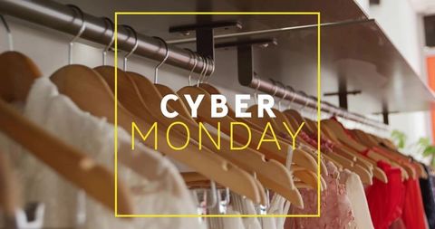 Cyber monday boutique clothing rack with wooden hangers and pastel to red dresses